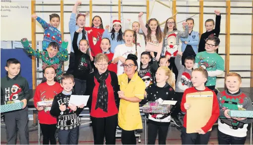  ?? ?? Bringing joy Care home resident Helen McGoogan (left) and activity co-ordinator Tracy O’Keefe gratefully accept the school’s gifts and cheque