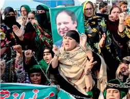  ?? AP ?? Grieving supporters of former prime minister Nawaz Sharif protest against the court ruling in Lahore; and, right, Sharif’s supporters shackle themselves to protest against the court ruling in Multan.