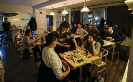  ?? DAVID COOPER/TORONTO STAR PHOTOS ?? The paper-covered tables and plain walls at Doma give no hint of either the ethnicity or complexity of the food, Amy Pataki writes.