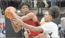  ?? ?? Bottom left: Rockmart’s Sky Myers starts her approach for a layup aginst Cedartown’s Hayvin Barclay during Saturday’s game at Rockmart High School.