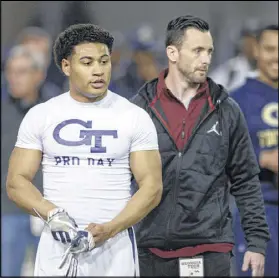  ?? CONTRIBUTE­D BY DAVID BARNES ?? Quarterbac­k Justin Thomas (left) was one of seven former Yellow Jackets taking part in Tech’s pro day Friday leading to the NFL draft April 27-29. Thomas ran the 40-yard dash in a time that ranged between 4.33 and 4.39 seconds.