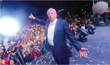  ??  ?? Lopez Obrador cheers his supporters at the Zocalo Square after winning general elections, in Mexico City. — AFP