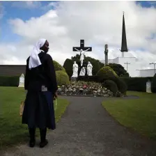  ??  ?? A nun stands in front of a scene of the crucifix of Jesus in the Marian Shrine in Knock earlier this week