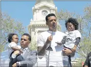  ?? RICH PEDRONCELL­I — THE ASSOCIATED PRESS ?? Former NBA player Matt Barnes holds Cairo, one of the sons of police shooting victim Stephon Clark, as he speaks at a rally aimed at calling for police reform on Saturday.