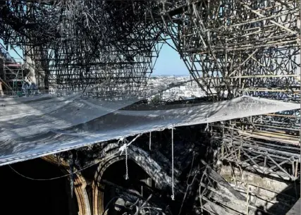  ?? Stephane de Sakutin/ Associated Press ?? Parts of a ribbed vault and scaffoldin­g, destroyed by fire, are pictured Wednesday at Notre Dame Cathedral in Paris. The chief architect of France’s historic monuments says that three months after the April 15 fire that devastated Notre Dame Cathedral the site is still being secured.