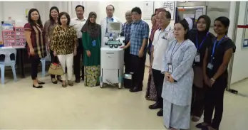  ??  ?? Dr Siti Hajar (fifth left) receives the apheresis platelet machine from Toh (eighth left) while other board members and hospital staff look on.