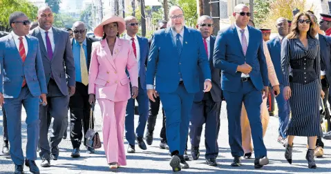  ?? ?? Opposition Leader Mark Golding (sixth left) leads members of the Opposition in both Houses on their walk towards Gordon House on Thursday. At front are (from left) Phillip Paulwell, Julian Robinson, Fitz Jackson, Janice Allen, Peter Bunting, Anthony Hylton, Mikael Phillips, and Lisa Hanna.