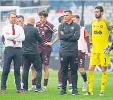  ?? ?? Deflated Hearts players and staff after the final defeat.