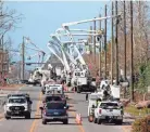  ?? HERBERT/AP GERALD ?? Utility crews set up new poles and wires in the aftermath of Hurricane Michael in Panama City, Fla.