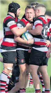  ??  ?? Celebratio­n scoring Andrew Goudie is mobbed after Crucial win