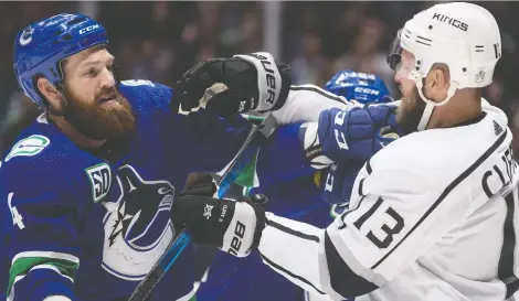  ?? DARRYL DYCK/THE CANADIAN PRESS ?? Canucks defenceman Jordie Benn, left, and Kyle Clifford of the Los Angeles Kings mix it up after the whistle during Wednesday’s 8-2 Canucks victory at Rogers Arena. Benn is a physical, no-nonsense type who appears to have come to Vancouver exactly as advertised.