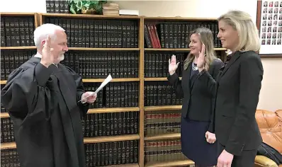  ?? Submitted photo ?? ■ Kelley Crisp, far right, is sworn in as first assistant district attorney this week by 202nd District Judge John Tidwell. Also pictured is Assistant District Attorney Lauren Richards renewing her oath. Crisp is the first woman in Bowie County’s history to hold the position of first assistant district attorney.