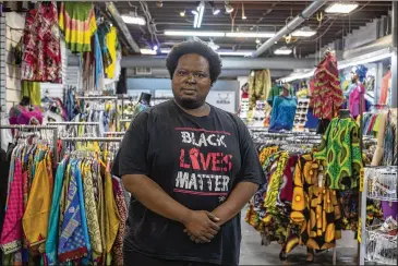  ?? ALYSSA POINTER/ALYSSA.POINTER@AJC.COM ?? Afro-centric Network manager Mugaisi Andega said the store benefits from the mall’s foot traffic, but he’s worried that a huge developmen­t similar to Midtown’s Atlantic Station would put him out of business.