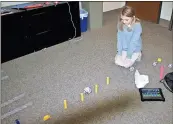  ?? / John Popham ?? Darlington student Nora Knaak controls a Cozmo robot with her iPad at the Darlington Tech Fair. She coded it to maneuver obstacles, push a block and even say phrases.