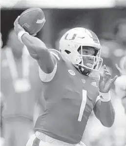  ?? JOHN BAZEMORE/AP ?? Miami quarterbac­k D’Eriq King throws during the first half of the team’s opening loss against Alabama.