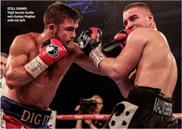  ?? Photo: NAOMI YOUD ?? STILL CHAMP: Yigit bursts inside and clumps Hughes with his left