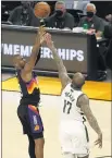  ?? CHRIS CODUTO — GETTY IMAGES ?? Phoenix’s Chris Paul shoots over Milwaukee’s P.J. Tucker during Game 1 of the NBA Finals on Tuesday. Paul scored 32points.