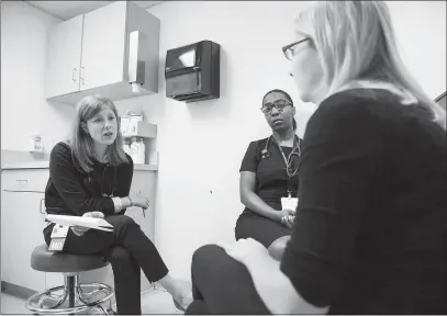  ??  ?? Dr. Lidya Wlasiuk and medical student Chioma Anyikwa, speak in June with patient Brooke Anglin, during a checkup visit at the South Boston Community Health Center. Wlasiuk teaches addiction awareness and interventi­ons at Boston University School of Medicine.