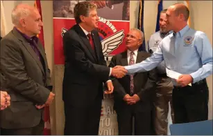  ?? Photo by Kendra Lolio ?? Lt. Gov. Dan McKee shakes the hand of Operation Stand Down RI's Executive Director Erik Wallin as mayors Joseph Polisena (left) and Charles Lombardi (center, back) look on.