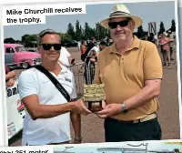  ?? ?? Mike Churchill receives the trophy.