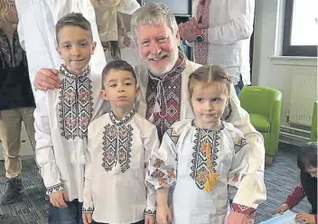  ?? ?? Dnipro Kids chairman Steven Carr with some of the kids in traditiona­l Vyshyvanka shirts