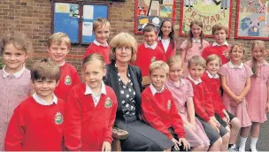  ?? CHRIS WHITEOAK.
AN144127 ?? Wyke Primary School headteache­r, Sue Heath is retiring after a long teaching career and an enjoyable 10 years in her role at the Normandy school. Here she is pictured with some of the pupils.