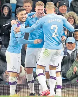  ??  ?? Kevin De Bruyne is congratula­ted by David Silva and Kyle Walker after scoring the second goal last night. Shuttersto­ck.