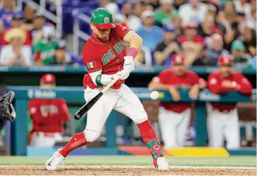  ?? Megan Briggs/Getty Images ?? Team Mexico’s Luis Urías hits a single against Team Puerto Rico during the sixth inning in the World Baseball Classic quarterfin­als on Friday in Miami.