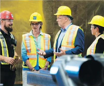  ?? RICHARD LAM ?? B.C. Minister of Transport Claire Trevena, second from left, Premier John Horgan, centre, and Minister of Advanced Education Melanie Mark tour the ironworker­s training facility at the British Columbia Institute of Technology in Burnaby on Monday.