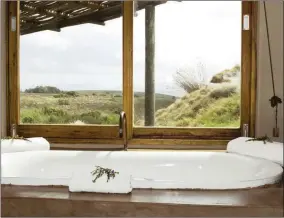  ??  ?? Take a long bath with scenic views of the reserve.