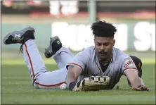  ?? JOE PUETZ – THE ASSOCIATED PRESS ?? Giants right fielder LaMonte Wade Jr. dives but is unable to catch a fly ball by the Cardinals' Paul Goldschmid­t during the third inning Sunday.