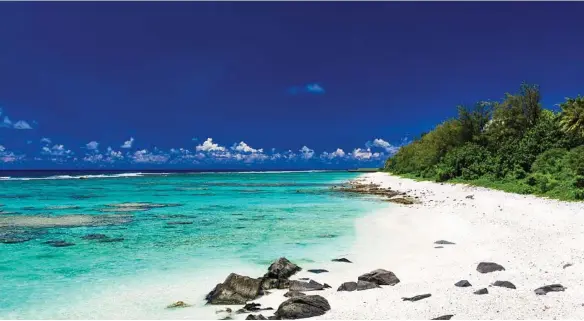  ?? PHOTOS: THINKSTOCK ?? HOLIDAY HEAVEN: Amazing beaches with white sand and black rocks on Rarotonga, Cook Islands and, below, tiki figures.