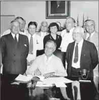  ?? AP ?? President Franklin Roosevelt signs the Social Security legislatio­n in Washington on Aug. 14, 1935.