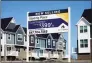  ?? Associated Press ?? An advertisin­g sign for building land stands in front of a new home constructi­on site in Northbrook, Ill., in March.