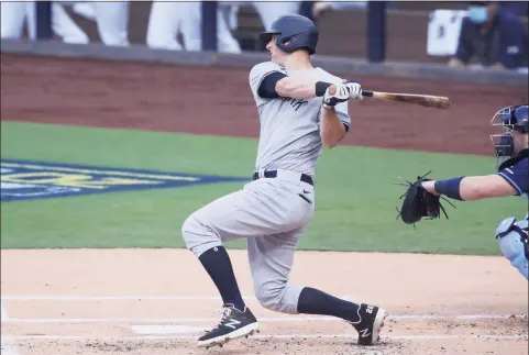  ?? Christian Petersen / Getty Images ?? The Yankees’ DJ LeMahieu hits a single against the Tampa Bay Rays during the first inning in Game 1 of the American League Division Series on Oct. 5.