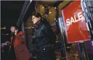  ??  ?? Two women walking out of a Beijing store yesterday. China will be handed the opportunit­y to reshape the rules for global trade and profit from a more isolated US if Trump abandons the TPP.