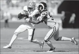  ?? Thearon W. Henderson Getty Images ?? RAMS’ CORY LITTLETON, tackling San Francisco’s Raheem Mostert, is the NFL’s best pass-coverage linebacker, says defensive coordinato­r Wade Phillips.