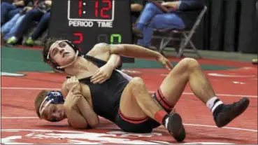  ?? JEN FORBUS — THE MORNING JOURNAL ?? Brendon Fenton of Elyria vies with Jake Canitano of Solon in a Division I 120-pound match of the state tournament on March 9.