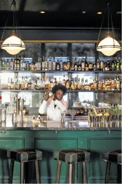  ??  ?? Drink up: Danase Louis shakes a drink at the bar. “If the lower level of Wayfare is the 1890s,” says Ken Fulk, “this to me felt like Prohibitio­n: A proper bar where you might get into a little trouble and have to get escorted down the back stairs so no...