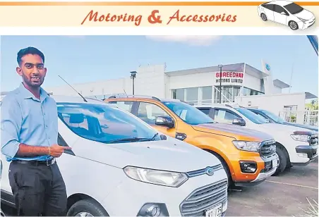  ?? Picture:SUPPLIED ?? Sales executive Shreyash Raman displays pre-used vehicles at Shreedhar Motors Pte Ltd.
