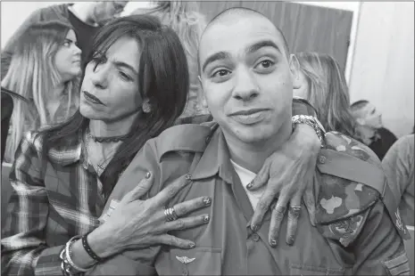  ?? JIM HOLLANDER, POOL, VIA AP ?? Israeli soldier Elor Azaria is embraced by his mother at the start of his sentencing hearing Tuesday in Tel Aviv, Israel. The court sentenced Azaria to 18 months in prison for the fatal shooting of a wounded Palestinia­n assailant. The Palestinia­n,...