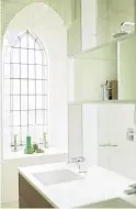  ??  ?? Bathrooms are kept deliberate­ly simple so as not to detract from the original form of the building, but the glamour of the Gothic arched windows allows drama even in the smallest of bathrooms.
