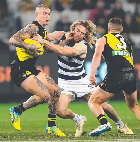 ??  ?? DON’T ARGUE: Cam Guthrie (centre) is likely to get first crack at Dustin Martin (left) on Friday night. Picture: GETTY IMAGES