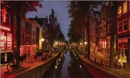  ?? ILVY NJIOKIKTJI­EN — THE NEW YORK TIMES ?? The red-light district in Amsterdam in 2021. New rules coming to Amsterdam in May will target crowding, disruptive behavior and noise in the city's most famous district.