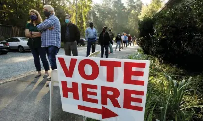  ?? Photograph: Jonathan Drake/Reuters ?? Voters wait in a 90-minute line to cast their ballots on the first day of the state’s in-person early voting for the national elections in Durham, North Carolina, on 15 October.