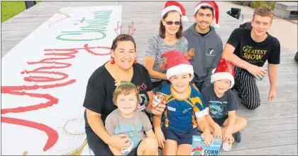  ??  ?? Ready for Te Puke’s Christmas in the Park — back row, organiser Monique Lints, Empowermen­tnz food bank manager Clare Cooper, Ciaran Mcgettigen and Sam Tomaszyk from the Charitable Dance Co with, front, Levi, Aiden and Dan Lints.