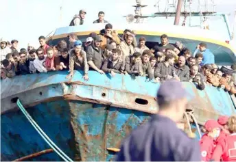  ?? AFP/VNA Photo ?? Rescued refugees and migrants stand on a boat at the town of Paleochora, southweste­rn Crete, in November 2022.