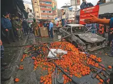  ?? AFP ?? Fruit is scattered across the street near a charred car after a fire that broke out in a market in the refugee camp of Nuseirat in central Gaza Strip yesterday.