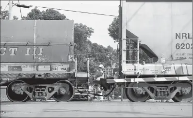  ?? Arkansas Democrat- Gazette/ THOMAS METTHE ?? A Union Pacific Railroad worker watches a train leaves Thursday afternoon after a car and a train wreck that left two people dead and another injured in Wabbaseka.