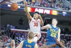  ?? Robert Gauthier Los Angeles Times ?? USC GUARD Elijah Stewart slams home a basket over UCLA forward TJ Leaf during the second half of a game Jan. 25. USC won, 84-76.